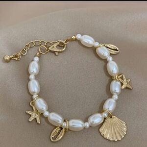 Pearls and charms bracelet gold plated